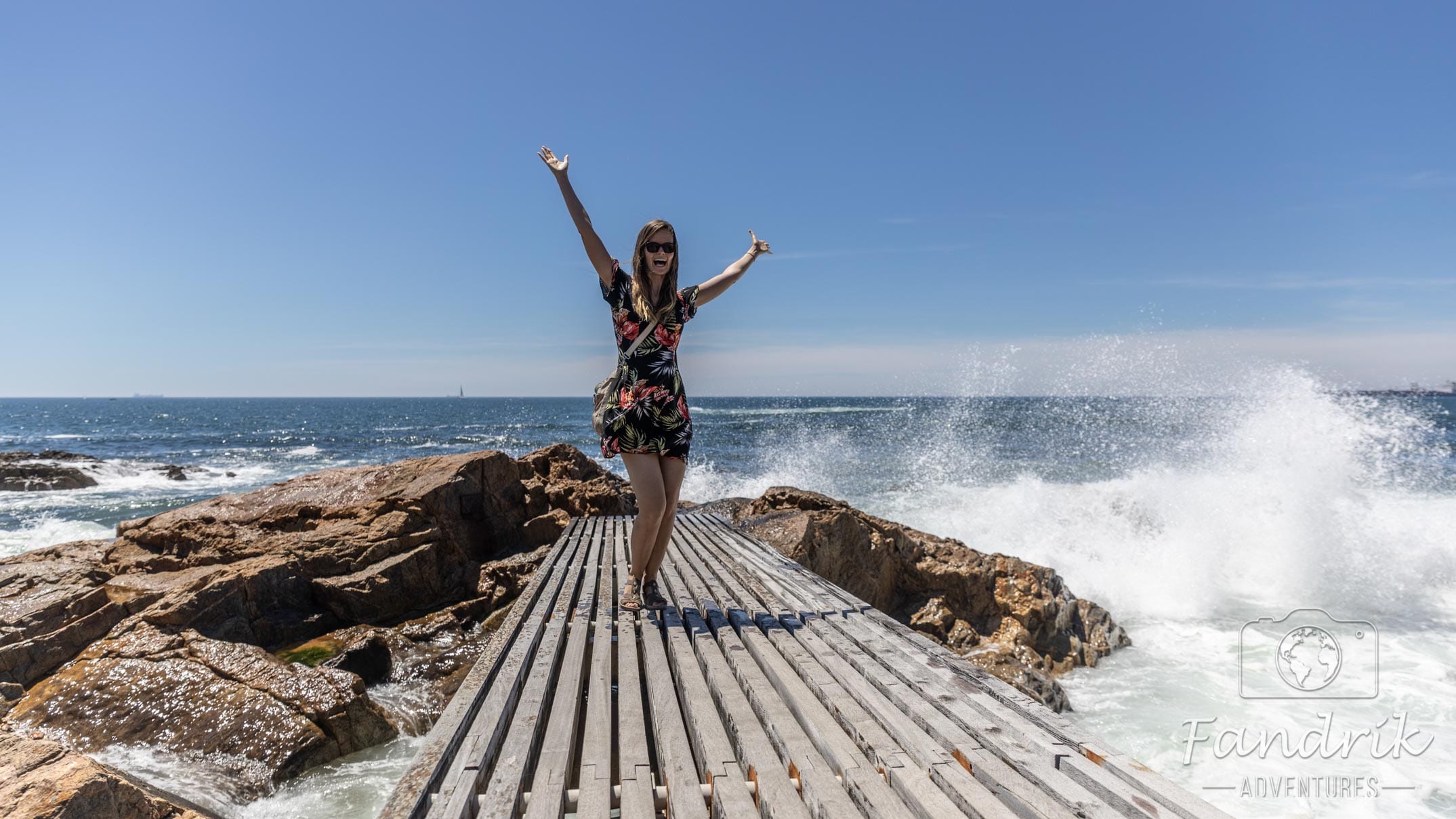 A woman poses on a wooden walkway on the Atlantic coast off Portugal.